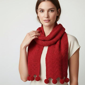 Woman wearing a chunky red crochet scarf with pom-pom trim, easy PDF crochet pattern